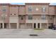 Attractive townhome featuring a tandem two-car garage and classic architectural elements at 6107 Metrowest Blvd # 104, Orlando, FL 32835