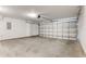 Spacious two car garage with a finished concrete floor and white walls at 6107 Metrowest Blvd # 104, Orlando, FL 32835