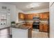 A spacious kitchen with stainless steel appliances, tile backsplash, and hardwood floors at 6107 Metrowest Blvd # 104, Orlando, FL 32835