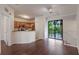 Open living area showing the kitchen, staircase, and hardwood flooring, perfect for entertaining at 6107 Metrowest Blvd # 104, Orlando, FL 32835