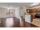 Bright living room with hardwood floors that lead to the open kitchen and dining space at 6107 Metrowest Blvd # 104, Orlando, FL 32835