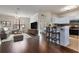 Open concept living room and kitchen area with wood floors and stainless steel appliances at 6107 Metrowest Blvd # 104, Orlando, FL 32835