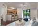 Bright living room open to the kitchen with stainless steel appliances and a balcony with views at 6107 Metrowest Blvd # 104, Orlando, FL 32835