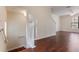 Open-concept living room with hardwood floors flowing into the staircase and second floor at 6107 Metrowest Blvd # 104, Orlando, FL 32835