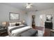 Spacious main bedroom featuring a ceiling fan, large bed, and walk in closet at 6107 Metrowest Blvd # 104, Orlando, FL 32835