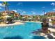Resort-style community pool with lounge chairs and lush landscaping at 6107 Metrowest Blvd # 104, Orlando, FL 32835