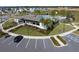 Community clubhouse and pool with palm trees, playground and parking area at 7032 Rolling Leaf Rd, Groveland, FL 34736