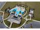 Aerial view of community pool and amenity center, including playground and lounge areas at 7032 Rolling Leaf Rd, Groveland, FL 34736