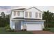 Charming two-story home featuring a two-car garage and a beautifully designed exterior at 7032 Rolling Leaf Rd, Groveland, FL 34736