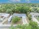 Aerial shot of a home highlighting its roof, driveway, and surrounding lush greenery at 806 Bear Lake Rd, Apopka, FL 32703