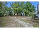 Large backyard with mature trees, providing ample shade, and a utility shed at 806 Bear Lake Rd, Apopka, FL 32703