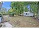 Spacious backyard with lush greenery, fire pit, storage shed, and ample seating area at 806 Bear Lake Rd, Apopka, FL 32703