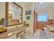 Bathroom featuring a vanity area with a large, ornate mirror and tiled shower at 806 Bear Lake Rd, Apopka, FL 32703