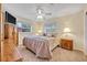 Cozy bedroom featuring neutral walls, two windows, a ceiling fan, and side tables with lamps at 806 Bear Lake Rd, Apopka, FL 32703