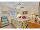 Relaxing bedroom with a floral-themed bed, comfortable chair, and soft lighting at 806 Bear Lake Rd, Apopka, FL 32703