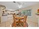 Bright kitchen dining area with tile flooring, a round wood table and a view of the white kitchen at 806 Bear Lake Rd, Apopka, FL 32703