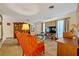 Comfortable living room boasting carpet flooring, a large TV, vintage furniture, and a built-in bookshelf at 806 Bear Lake Rd, Apopka, FL 32703