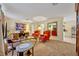 Bright and airy living room featuring carpet floors, vintage furniture, and plenty of natural light from the windows at 806 Bear Lake Rd, Apopka, FL 32703