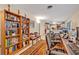 Functional home office featuring multiple workstations and a well-stocked bookshelf adjacent to the kitchen area at 806 Bear Lake Rd, Apopka, FL 32703