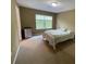 Bedroom featuring carpet flooring, neutral colored walls, window and queen sized bed with floral bedspread at 8417 Leeland Archer Blvd, Orlando, FL 32836