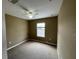 A carpeted bedroom with a ceiling fan and a window at 8417 Leeland Archer Blvd, Orlando, FL 32836