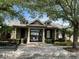 View of the community clubhouse with lush landscaping at 8417 Leeland Archer Blvd, Orlando, FL 32836