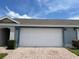 A two-car garage door with brick-paved driveway at 8417 Leeland Archer Blvd, Orlando, FL 32836
