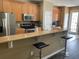 Open kitchen with stainless steel appliances, breakfast bar, and ample cabinet space, perfect for cooking at 8417 Leeland Archer Blvd, Orlando, FL 32836