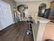 Open concept view of the kitchen featuring a countertop with bar stool seating and wood laminate flooring at 8417 Leeland Archer Blvd, Orlando, FL 32836