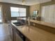 Spacious kitchen featuring stone countertops, a breakfast bar, and plenty of cabinet space for storage at 8417 Leeland Archer Blvd, Orlando, FL 32836
