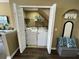 View of laundry room with full size washer and dryer and storage shelf inside of a utility closet at 8417 Leeland Archer Blvd, Orlando, FL 32836