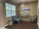 Cozy living area with stylish decor, featuring a modern light fixture, elegant furniture, and a bright window at 8417 Leeland Archer Blvd, Orlando, FL 32836