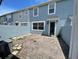 A brick patio with a blue exterior and privacy wall at 8417 Leeland Archer Blvd, Orlando, FL 32836