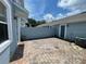 Brick-paved patio area with an AC unit and privacy wall at 8417 Leeland Archer Blvd, Orlando, FL 32836