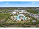 Aerial view of community clubhouse amenities, including a resort-style pool and recreational facilities at 867 Bama Breeze Dr, Daytona Beach, FL 32124