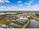 Expansive aerial view showcasing the community, amenities, and surrounding landscape at 867 Bama Breeze Dr, Daytona Beach, FL 32124