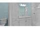 Bathroom featuring white cabinetry, granite countertops, a tiled shower with glass doors, and a toilet at 867 Bama Breeze Dr, Daytona Beach, FL 32124