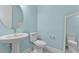Powder room featuring pedestal sink, toilet and large mirror at 867 Bama Breeze Dr, Daytona Beach, FL 32124