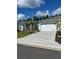 A well-manicured lawn and paver driveway lead up to this charming home with a 2-car garage at 867 Bama Breeze Dr, Daytona Beach, FL 32124