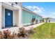 Bright home exterior with a welcoming blue front door and well-maintained landscaping at 867 Bama Breeze Dr, Daytona Beach, FL 32124