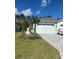 Charming home with a paver driveway, a two-car garage, and well-maintained landscaping at 867 Bama Breeze Dr, Daytona Beach, FL 32124
