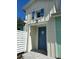 Charming front entrance featuring a blue door, blue shutters, and neutral siding at 867 Bama Breeze Dr, Daytona Beach, FL 32124