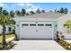 Charming home featuring a spacious white garage door and a beautiful paver driveway at 867 Bama Breeze Dr, Daytona Beach, FL 32124