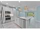 Bright, open kitchen featuring stainless steel appliances, an island, and access to the living area at 867 Bama Breeze Dr, Daytona Beach, FL 32124