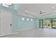 Spacious living room with light wood floors, recessed lighting, and sliding door to screened lanai at 867 Bama Breeze Dr, Daytona Beach, FL 32124