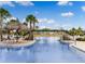Lazy river pool with bridge, lush landscaping, and lounge chairs at 867 Bama Breeze Dr, Daytona Beach, FL 32124