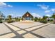 Outdoor stage with thatch roof, offering a central gathering spot for entertainment at 867 Bama Breeze Dr, Daytona Beach, FL 32124