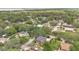 Expansive aerial view of a neighborhood with mature trees, showcasing lush landscaping and nearby water views at 900 S Palmetto Ave, Sanford, FL 32771