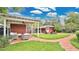Charming backyard featuring a covered patio, outdoor seating area, and lush landscaping at 900 S Palmetto Ave, Sanford, FL 32771