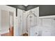 Bathroom featuring a glass-enclosed shower with tile surround, chrome fixtures, and neutral color scheme at 900 S Palmetto Ave, Sanford, FL 32771